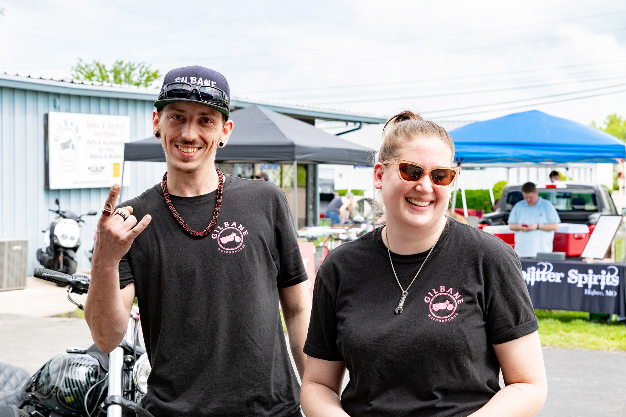 Two people attending Gilbane Motorsports block party