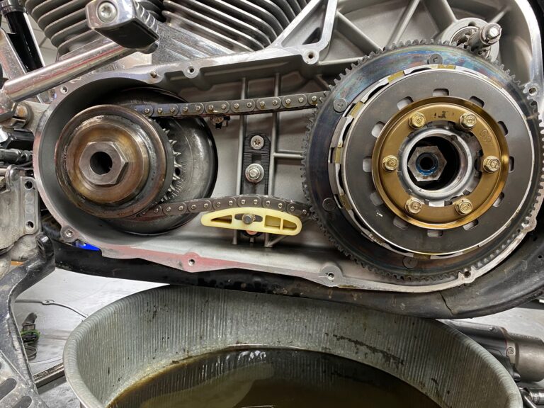 Motorcycle engine with drip pan below